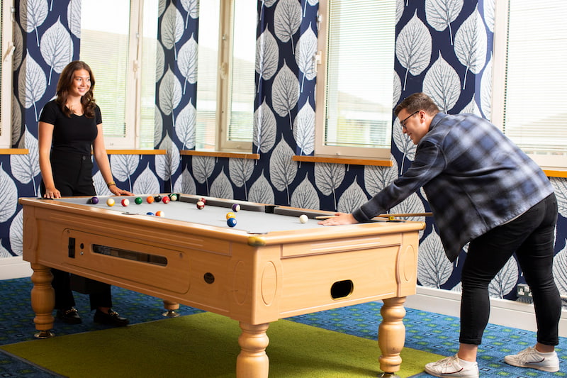 two people playing pool in a breakout space at Kents Hill Park